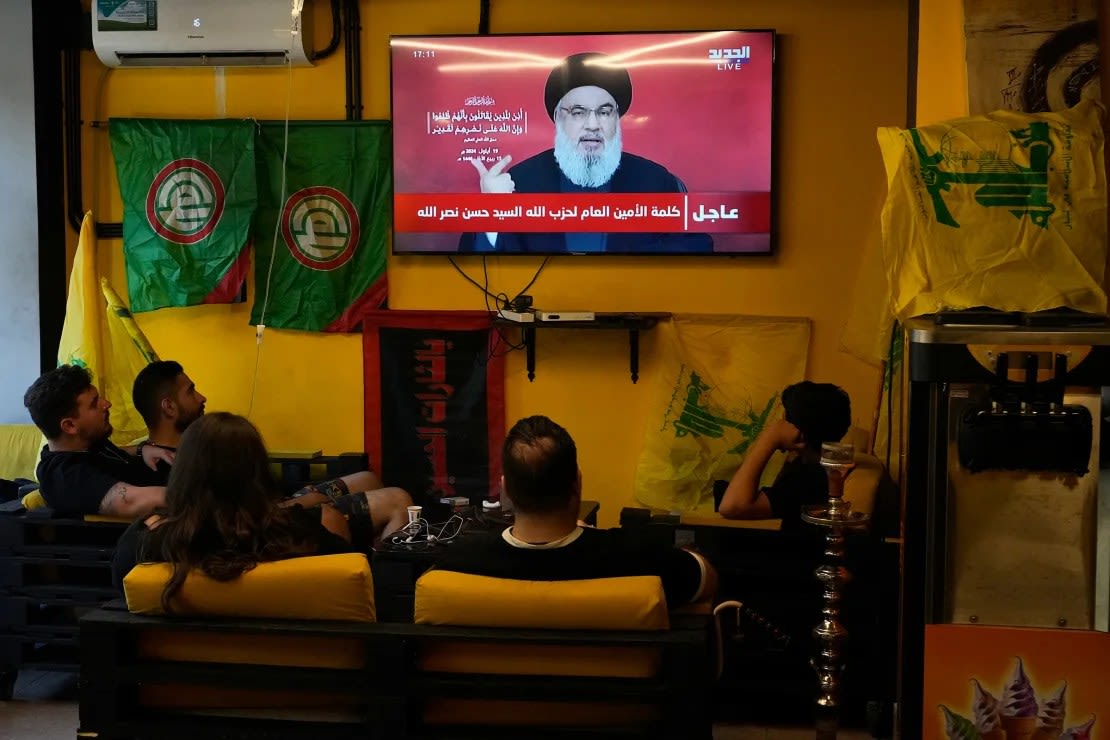 A group sits in a cafe in Beirut to watch a speech by Nasrallah on September 19. This comes after Israel bombed across Lebanon targeting Hezbollah fighters. Many of the dead were civilians.