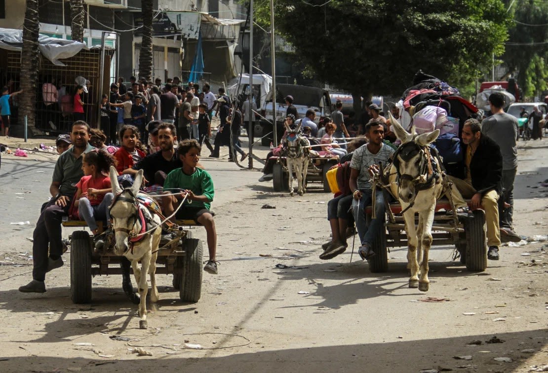 Palestinians flee with what few belongings they can carry after an Israeli attack on the Jabalya camp on October 8.