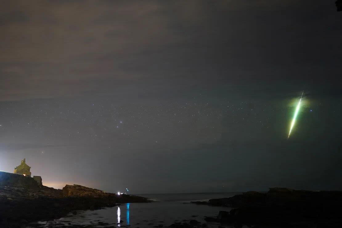 In October 2021, a meteor streaked across the sky during the Draconite meteor shower over Hawick Rocks in Northumberland, northeast England. Owen Humphreys/PA Media/FILE