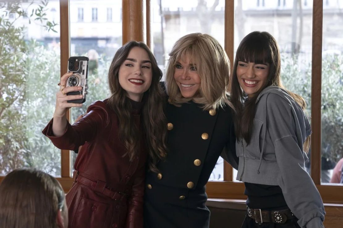 Brigitte Macron (centre) appeared in an episode where she posed for a selfie with Lily Collins as Emily (left) and Thalia Besson as Geneviève (right). Credit: Netflix.