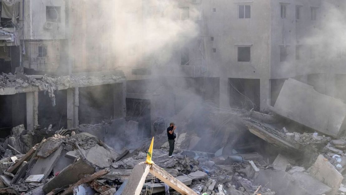 A man stands in the rubble near the site where Hezbollah leader Hassan Nasrallah was assassinated in the southern suburbs of Beirut on September 29, 2024.