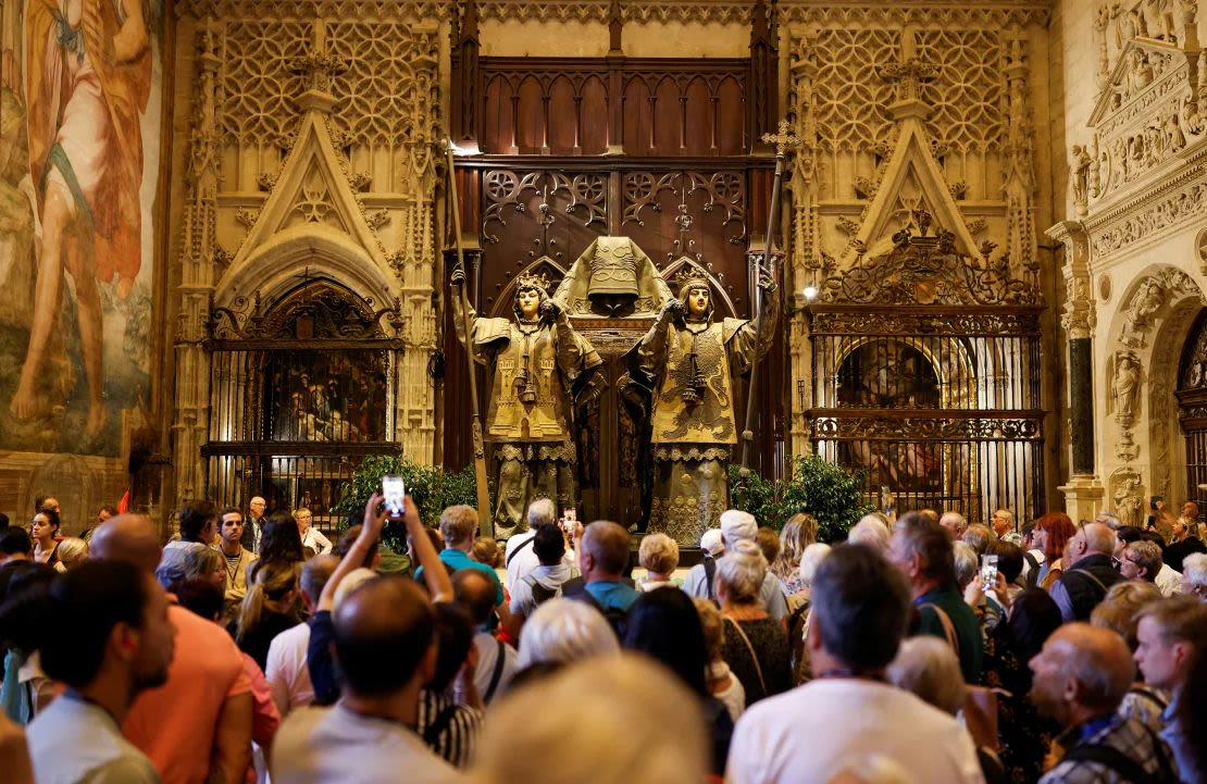 A group of people visit the tomb of Christopher Columbus at the cathedral in Seville, Spain on October 11, 2024.